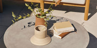 A Neighbor round concrete coffee table on a sunny patio