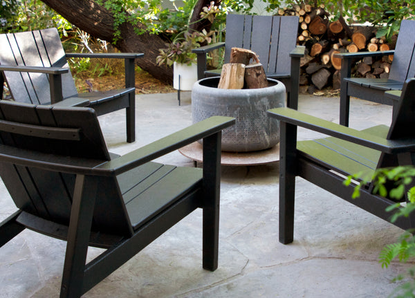 Neighbor Low Chairs in black surround a portable fire pit