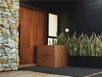 A set of Neighbor shipping boxes sitting on a quiet porch after delivery