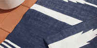 A close up shot of a Neighbor Mesa rug in indigo blue