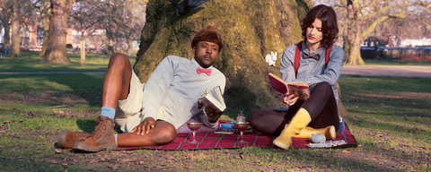 Picnic Scene of a man and woman wearing bow ties and suspenders