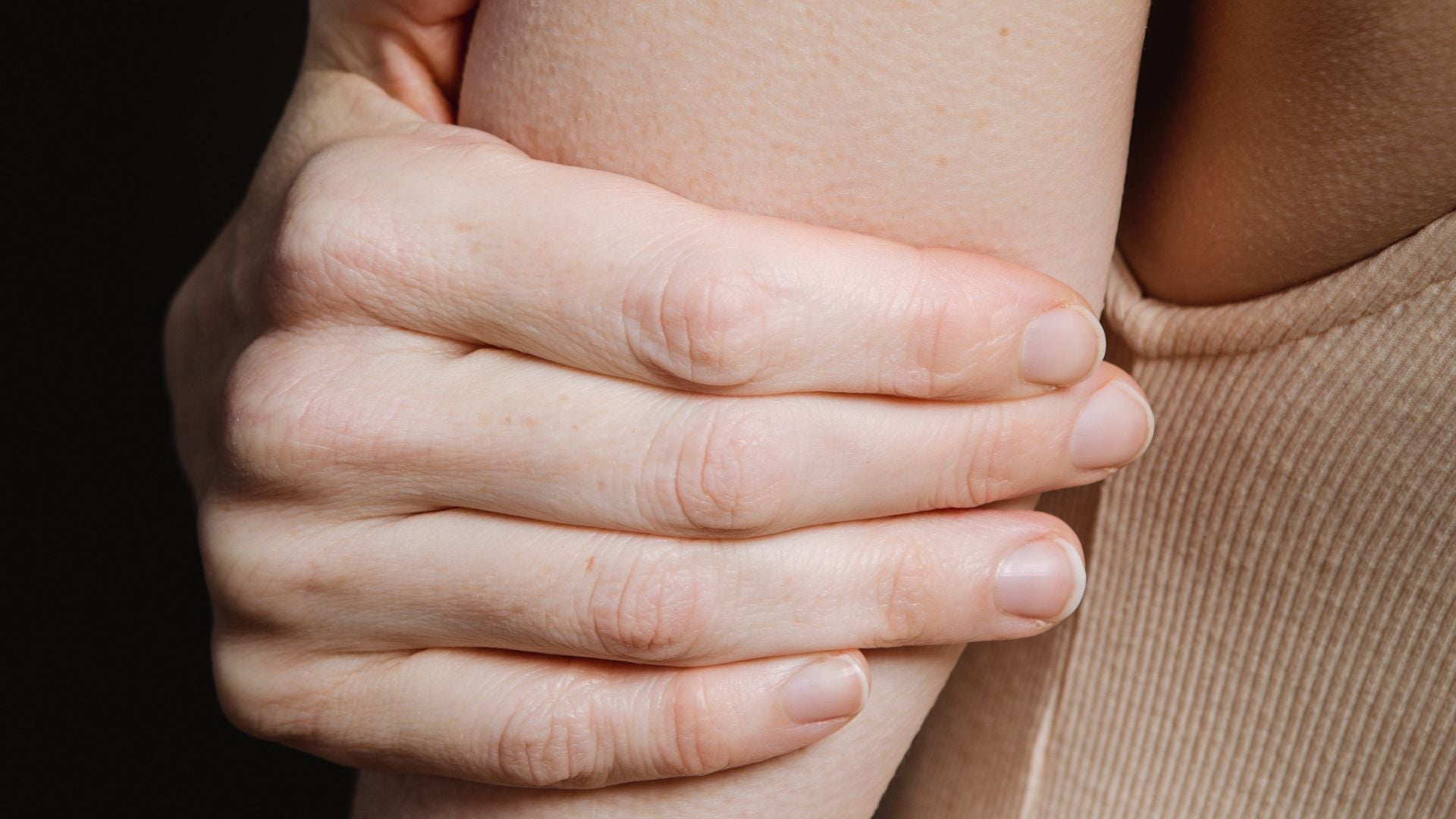 Close up of hand on arm