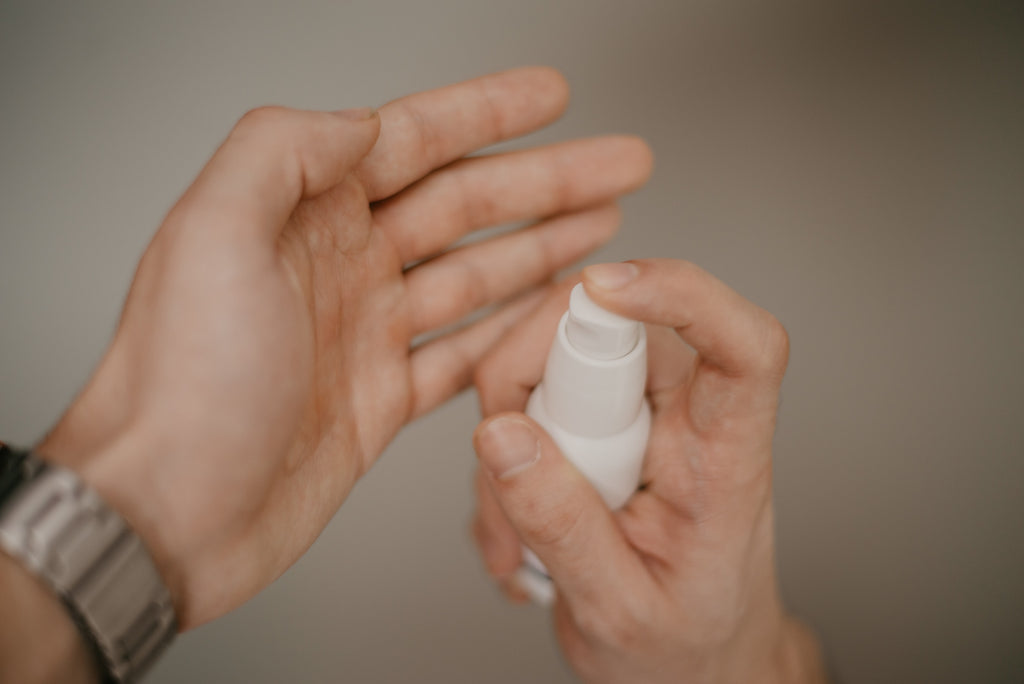 the man applies the cosmetic from the white package on his hands