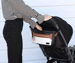 woman pushing stroller with itzy ritzy diaper caddy