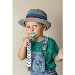 little boy in a cute hat using the teething lanyard 