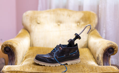 Stretcher in shoe sitting on yellow armchair