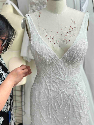 beaded wedding dress being hand sewn