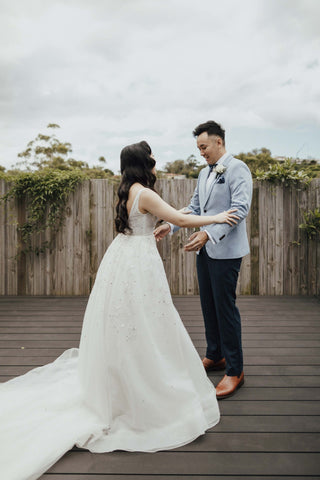 bride and groom doing first look on their wedding day in wedding attire