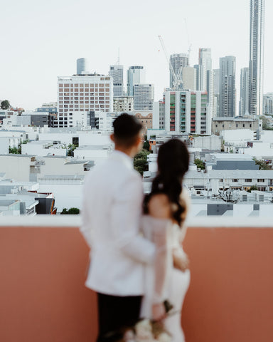 bride and groom hugging overlooking Brisbane city