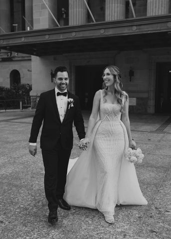 bride and groom walking hand in hand on their wedding day