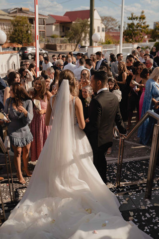 bride and groom walking through crowd of guests at wedding
