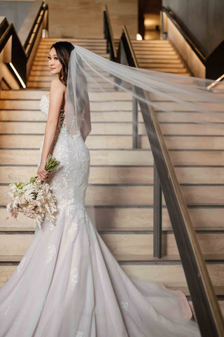 bride posing for wedding portraits on staircase