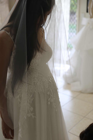 bride wearing her white lace wedding dress