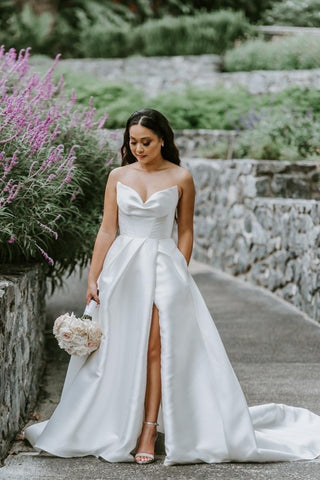 bride wearing wedding dress walking through garden