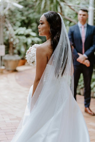 bride wearing wedding wedding dress and long tulle veil