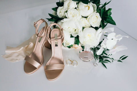 brides wedding day accessories of heels flowers jewellery and perfume