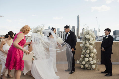 celebrant fixing brides veil at wedding