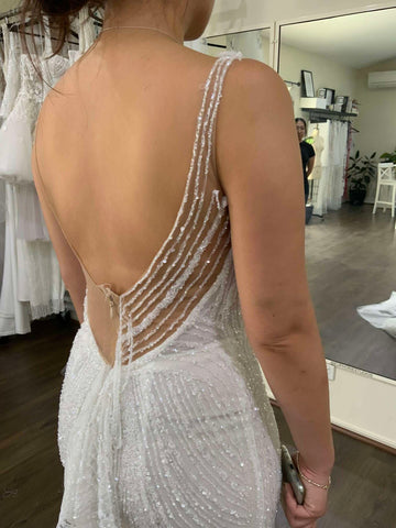 half sewn wedding dress on womans body