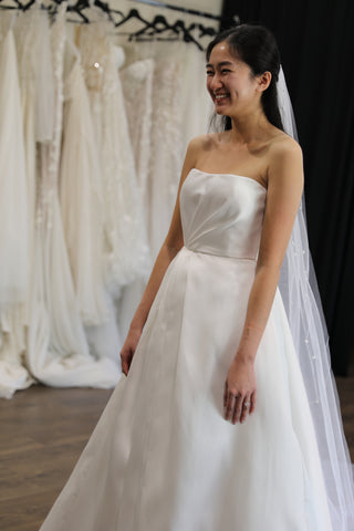 happy bride smiling in her wedding dress