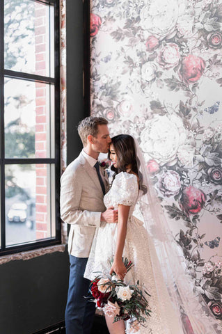 man kissing his wife on her forehead