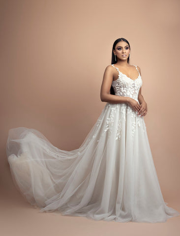 model posing in wedding dress with floating gown train
