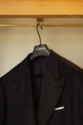 suit jacket on coat hanger hanging in closet