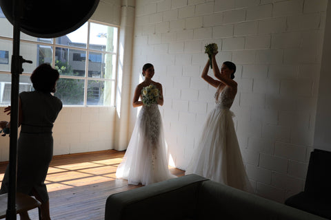 three women doing a bouquet toss at a photoshoot