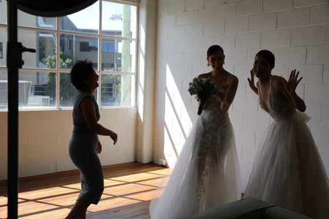 three women tossing bouquet at photoshoot