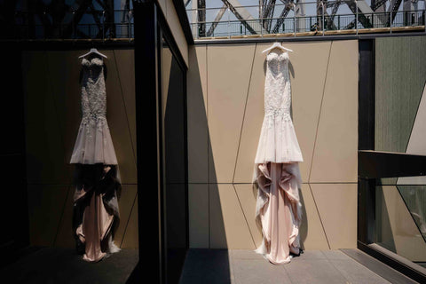 wedding gown on coat hanger hanging from wall