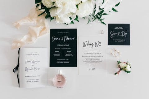 wedding invitations and bouquets laid out on table