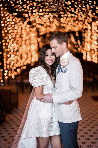 wife hugging her husband at their wedding reception