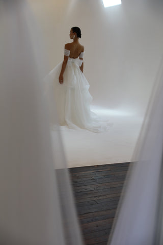 woman dancing on white floor in wedding gown