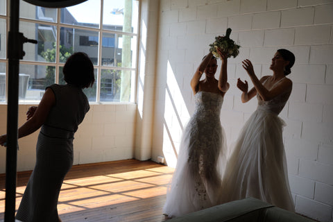 women tossing bridal bouquet