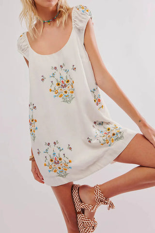 Experience the carefree style of the Wildflower Mini Dress by Free People. Featuring delicate floral embroidery, a shapeless silhouette, and a low scoop neckline, this playful mini dress is perfect for any occasion. Let your femininity shine in this effortless and whimsical piece.