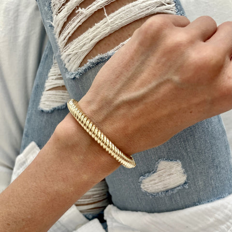 Stunning chunky 14k gold twist cable bangle worn by a female model