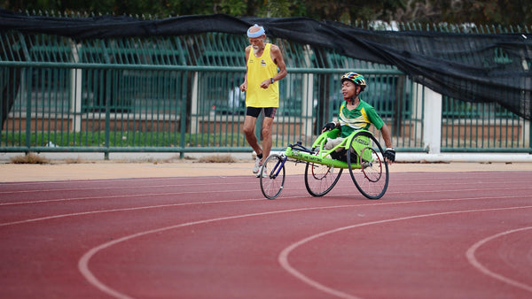 man in wheelchair participating in sports