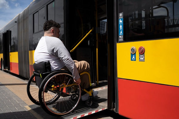man in wheelchair accessing bus