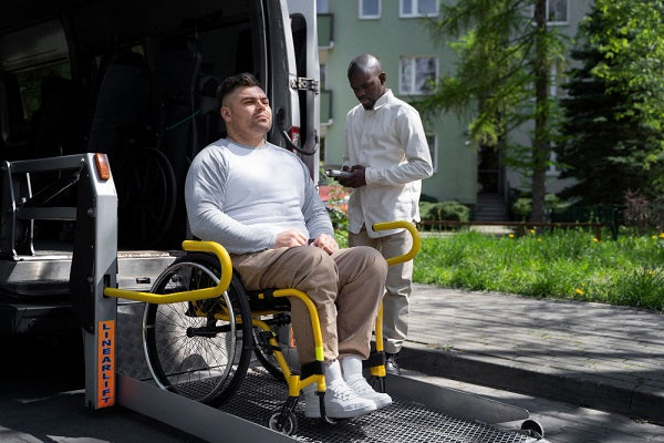 man in wheelchair on vehicle ramp