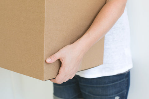 Person holding brown box