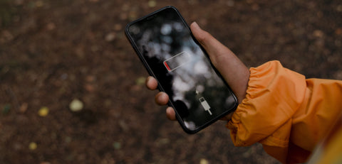 Woman holding phone with no charge