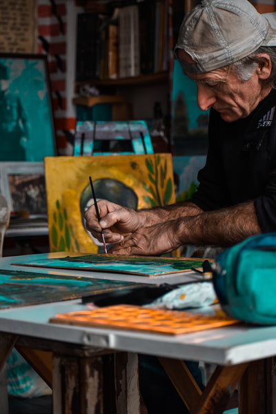A photo of a man painting