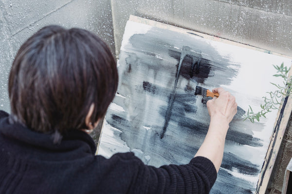 A photo of a painter doing an abstract painting