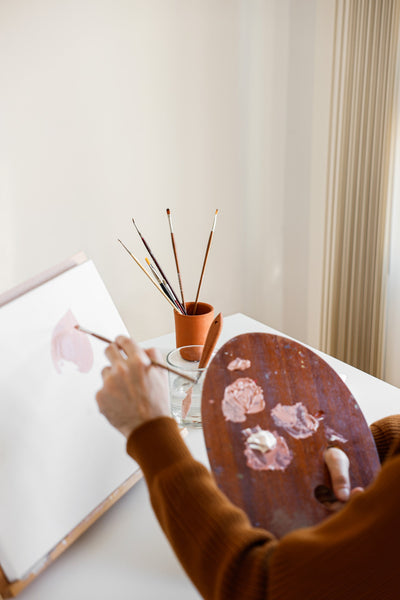 A photo of a person holding brown wooden round table