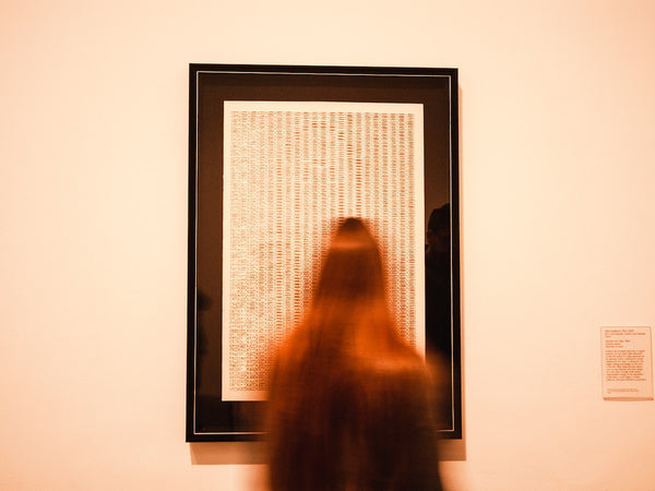 A photo of a person looking at the portrait