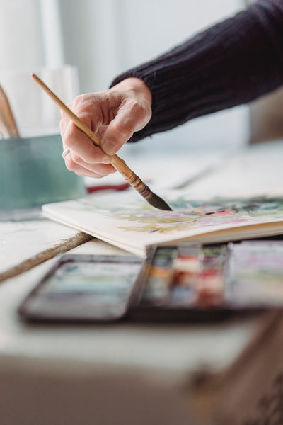 A photo of a person painting an artwork