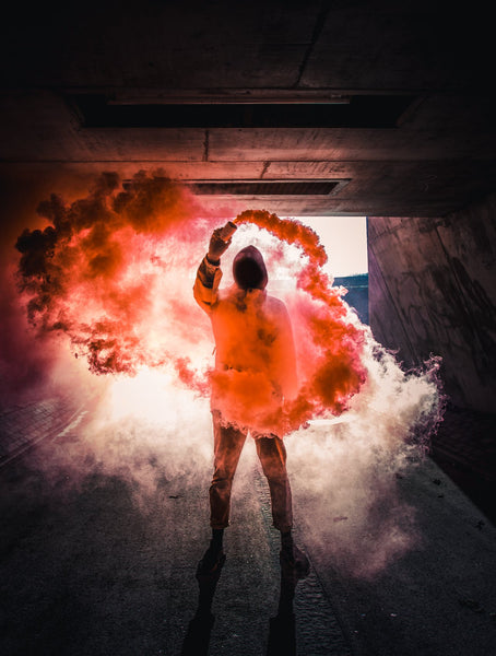 A photo of a person with colored smoke