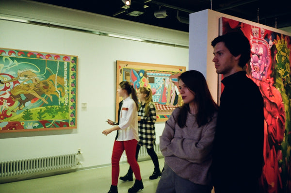 A photo of a woman leaning on man standing inside a room