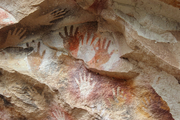 A photo of rock mountain cave cavern hands