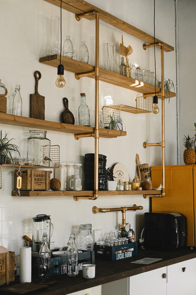 A photo of wooden shelves with glassware and various items