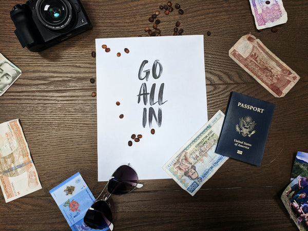 A photo showing a go all in signage in the midst of bank notes and a passport